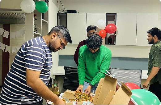 Team members celebrating with cake